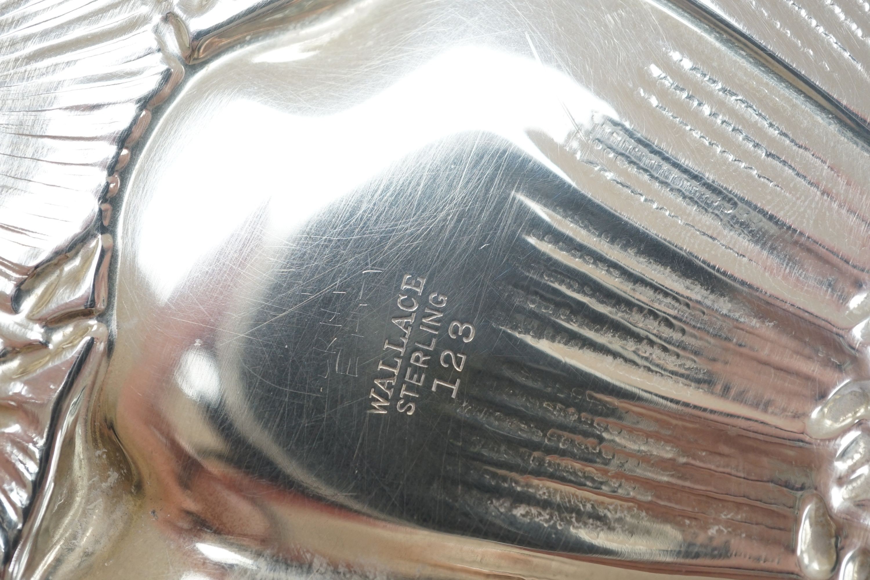 An American sterling embossed fruit bowl by Wallace, diameter 25.4cm and a Gorham sterling napkin ring, 150z.